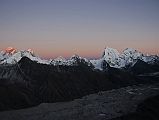 Gokyo Ri 08-1 Everest, Nuptse, Lhotse, Makalu, Cholatse, Tawache From Gokyo Ri Sunset Ends The last rays of the sun highlight Mount Everest and Lhotse, while a warm glow surrounds Nuptse, Makalu, Cholatse, and Taweche. The Nguzumpa Glacier is in shadow below.